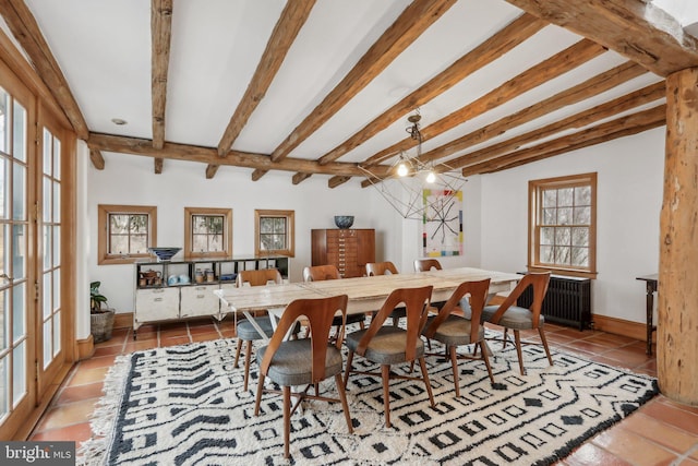 tiled dining space with baseboards, radiator heating unit, a chandelier, and beam ceiling