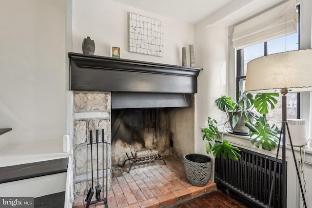 room details with radiator and a fireplace