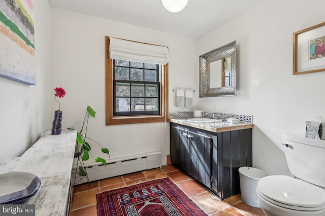 bathroom with toilet, tile patterned floors, a baseboard radiator, and vanity