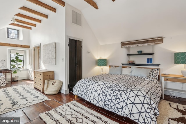 bedroom with beam ceiling, visible vents, wood finished floors, high vaulted ceiling, and baseboards