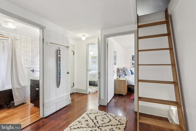 foyer with baseboards and dark wood-style flooring