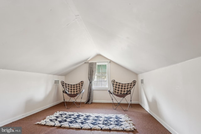 living area with vaulted ceiling, carpet floors, visible vents, and baseboards