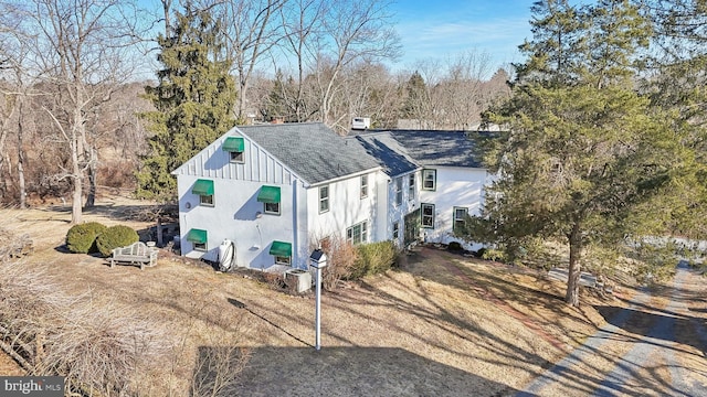 view of home's exterior featuring a chimney, board and batten siding, and roof with shingles