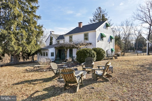 back of property with a chimney