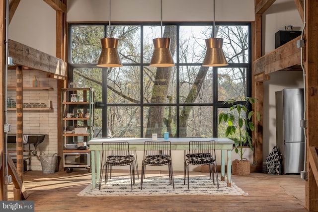 dining area with plenty of natural light and wood finished floors