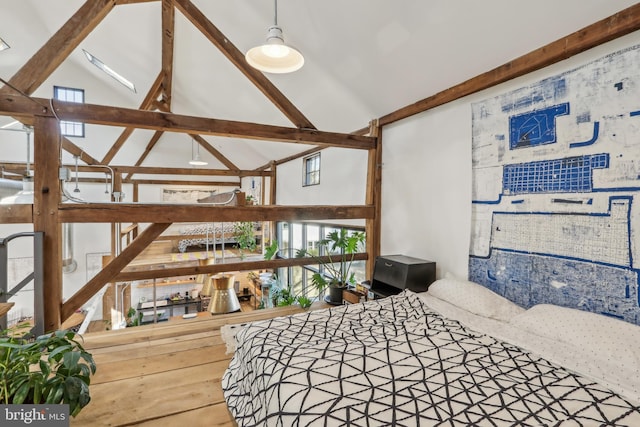 bedroom with high vaulted ceiling and beam ceiling