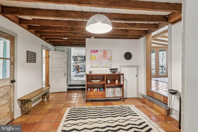 dining room featuring beam ceiling and tile patterned floors