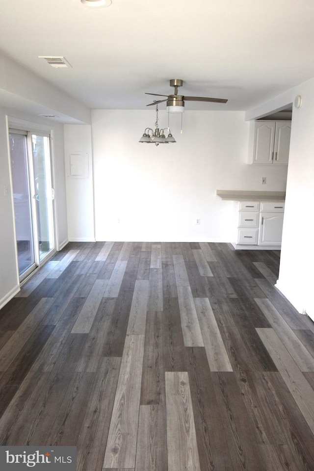 unfurnished dining area featuring ceiling fan, dark wood-type flooring, and visible vents