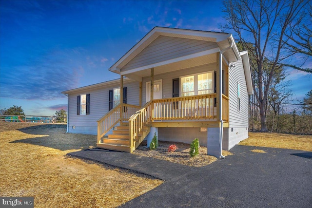 view of front of property featuring covered porch and crawl space