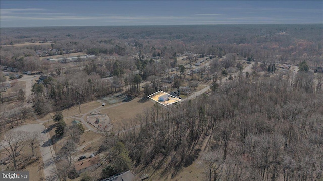 birds eye view of property with a wooded view