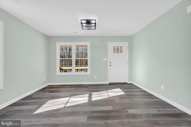 interior space featuring visible vents, baseboards, and wood finished floors