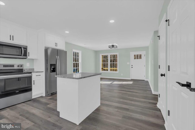 kitchen featuring white cabinets, stainless steel appliances, and dark wood finished floors