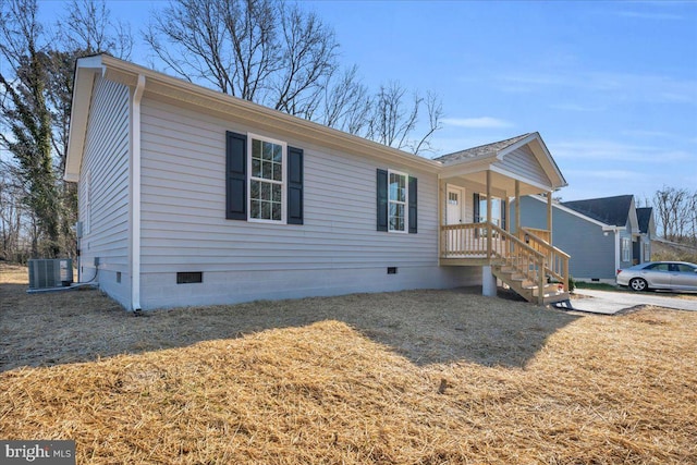 view of front of property featuring crawl space, covered porch, central AC unit, and a front yard