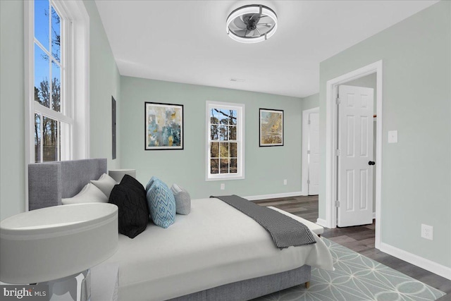 bedroom featuring baseboards and wood finished floors