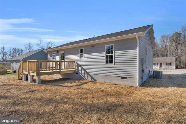 rear view of house with crawl space, a yard, a deck, and central AC unit