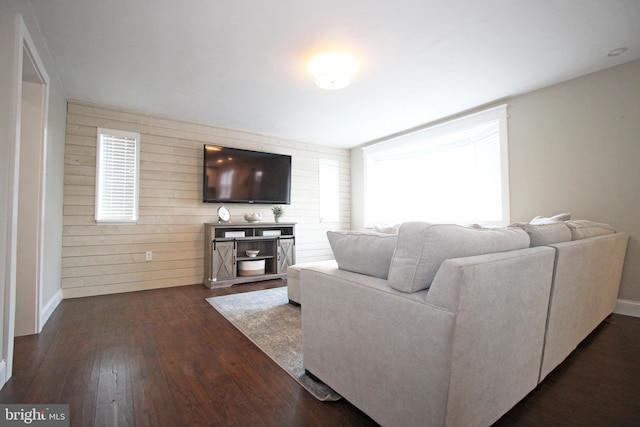 living room with dark wood-style flooring and baseboards