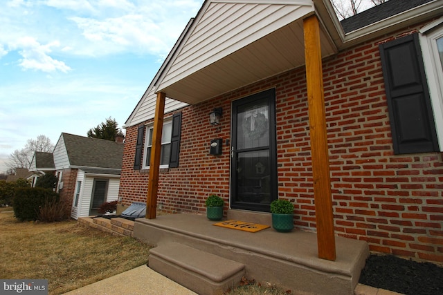 property entrance featuring brick siding