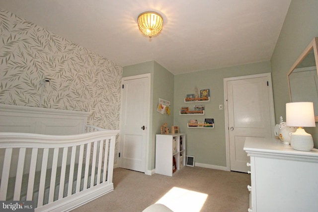 bedroom with wallpapered walls, baseboards, visible vents, and light colored carpet