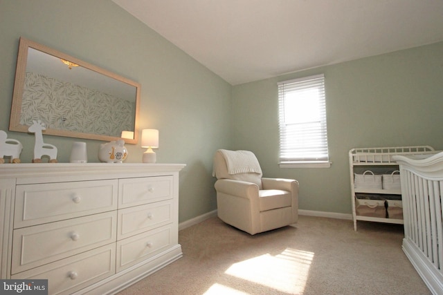 bedroom with light carpet, vaulted ceiling, and baseboards