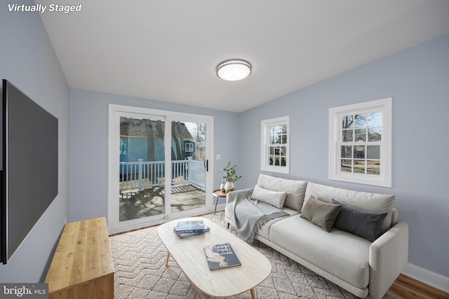 living room featuring baseboards and wood finished floors