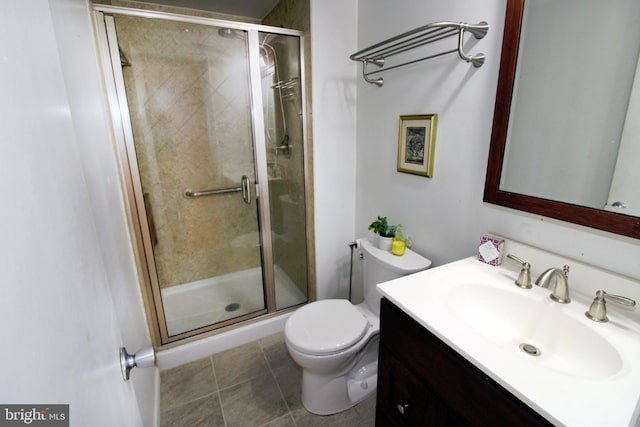 full bathroom featuring vanity, a shower stall, toilet, and tile patterned floors