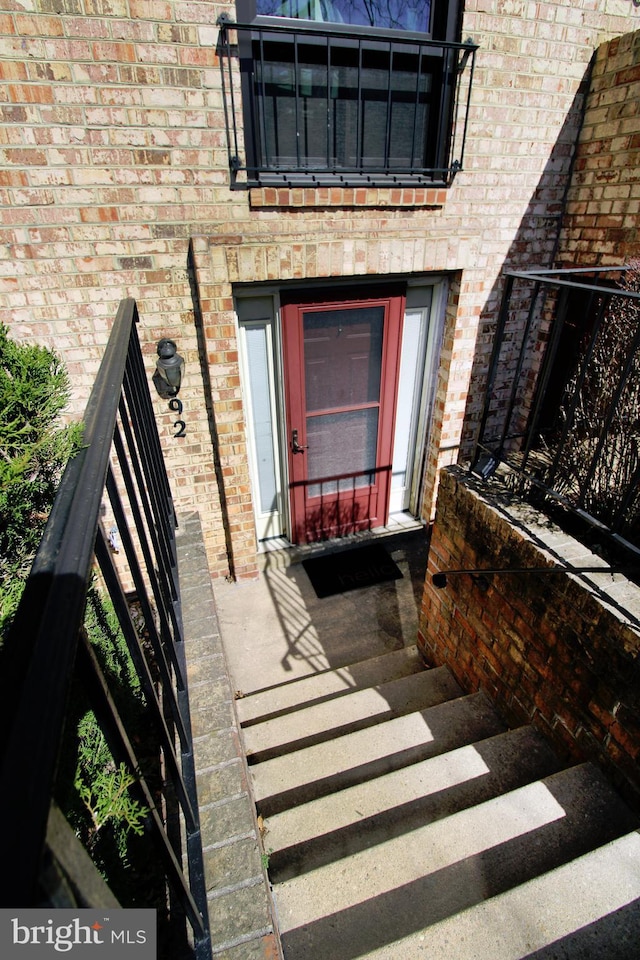 property entrance with brick siding