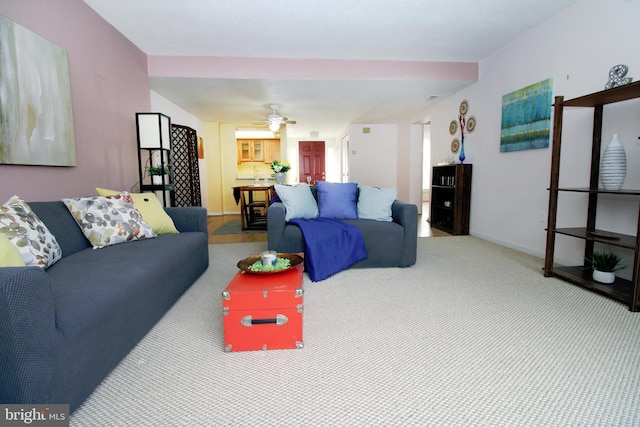 living room with a ceiling fan, baseboards, and carpet floors