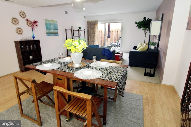 dining area with visible vents and light wood finished floors