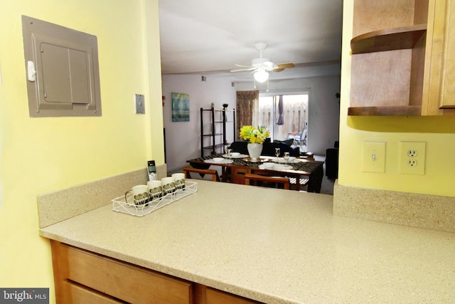 kitchen featuring electric panel, open shelves, and a ceiling fan