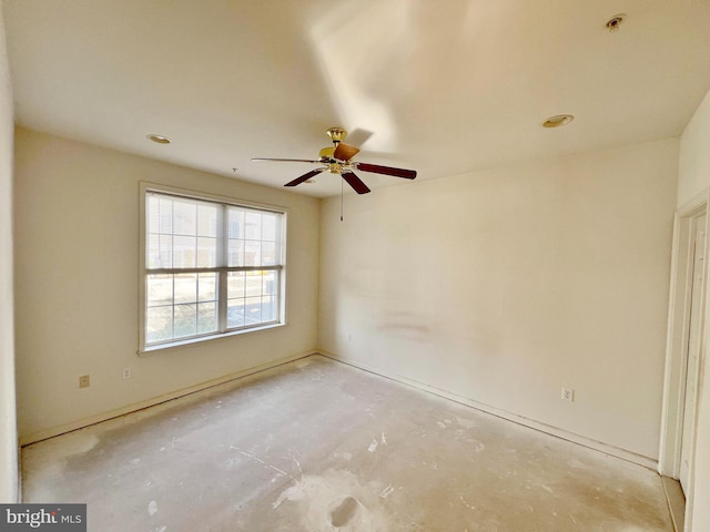 unfurnished room featuring ceiling fan and unfinished concrete flooring