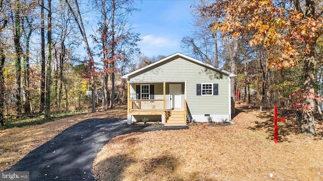 bungalow-style home featuring crawl space, aphalt driveway, and a porch