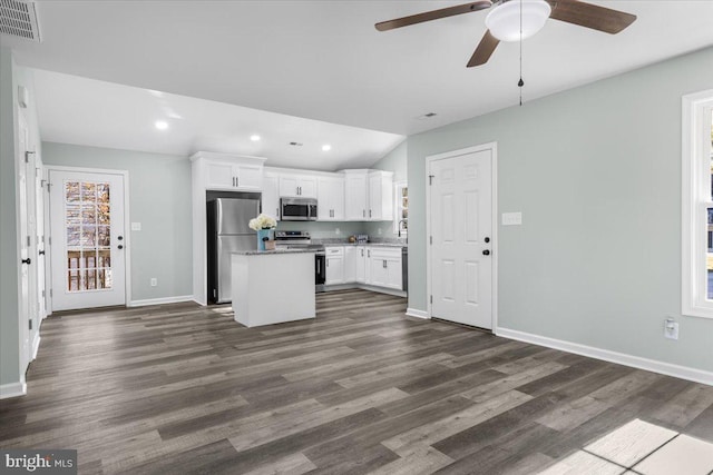 kitchen with visible vents, dark wood finished floors, appliances with stainless steel finishes, a center island, and white cabinetry