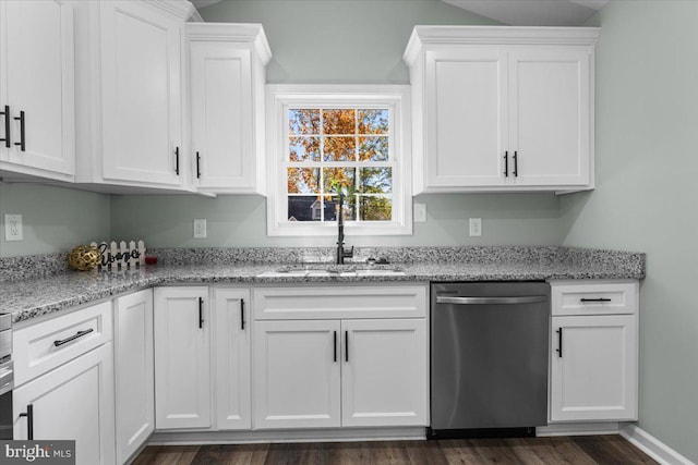 kitchen featuring a sink, white cabinetry, light stone counters, and stainless steel dishwasher