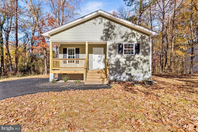 bungalow-style house with a porch and crawl space