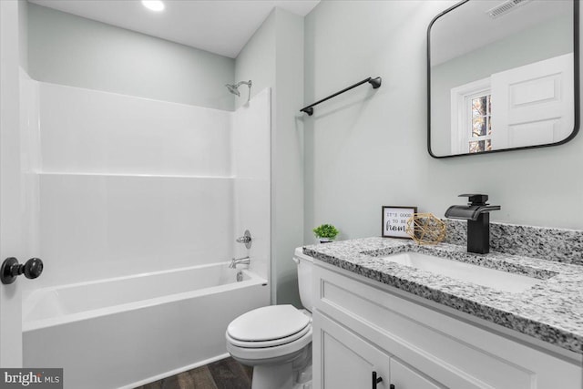 bathroom featuring shower / bath combination, visible vents, toilet, wood finished floors, and vanity