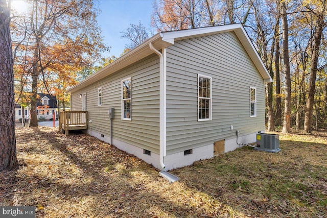 view of property exterior with crawl space and central air condition unit