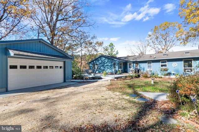 view of front of property with a garage and an outdoor structure