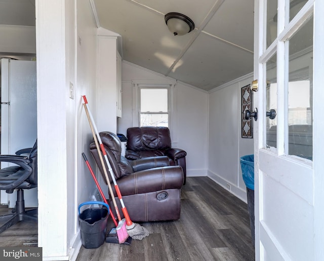 living area featuring vaulted ceiling and wood finished floors