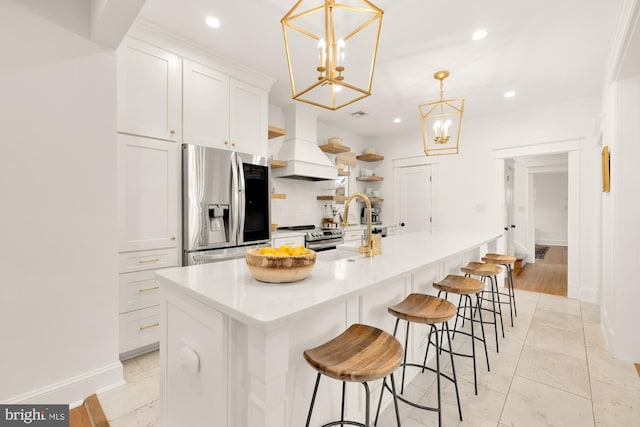 kitchen with tasteful backsplash, appliances with stainless steel finishes, custom exhaust hood, light countertops, and white cabinetry