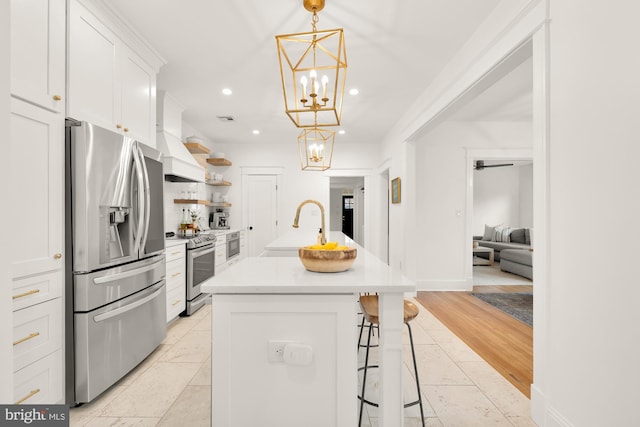 kitchen with appliances with stainless steel finishes, custom exhaust hood, light countertops, white cabinetry, and open shelves