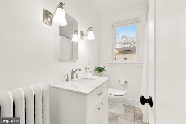 full bath with radiator, baseboards, vanity, and toilet