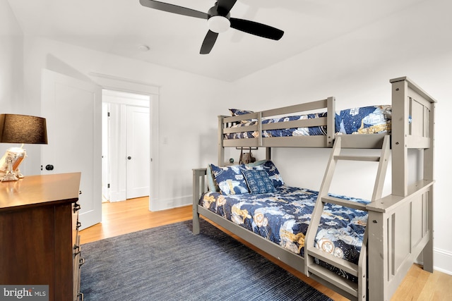 bedroom featuring ceiling fan, wood finished floors, and baseboards