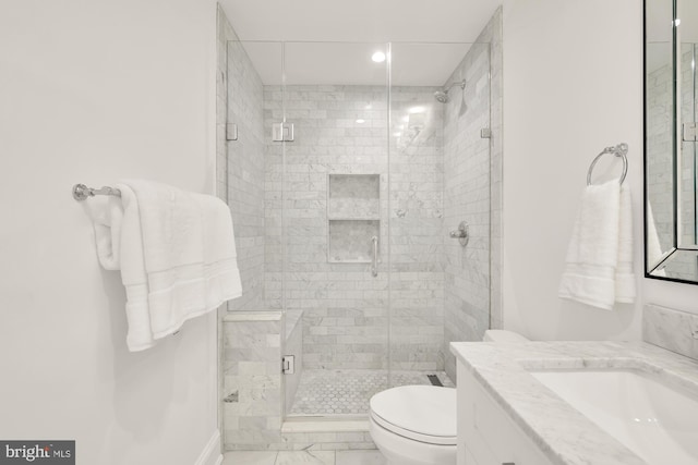 bathroom featuring a shower stall, vanity, toilet, and marble finish floor