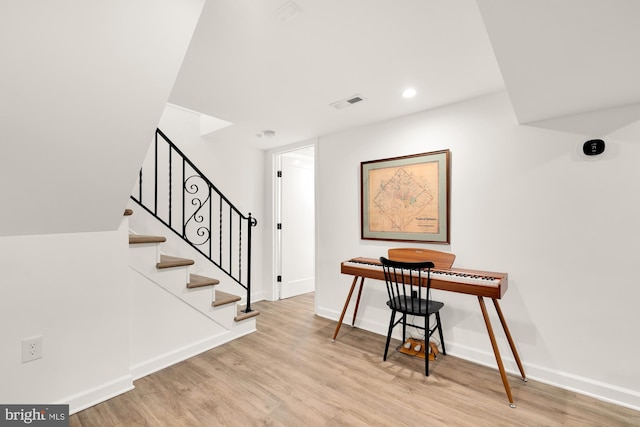 interior space featuring recessed lighting, visible vents, stairway, wood finished floors, and baseboards