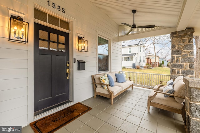 property entrance featuring covered porch and a ceiling fan