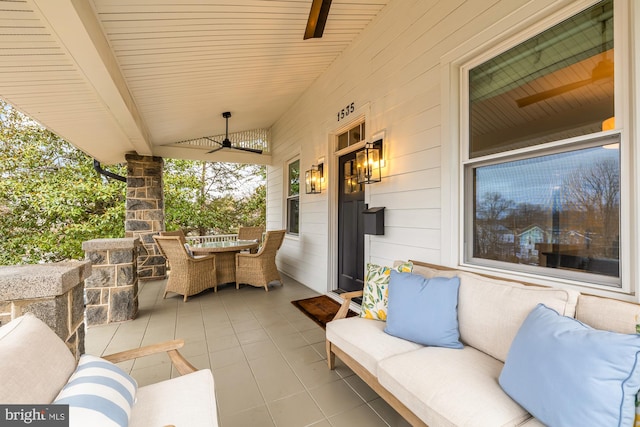 view of patio / terrace featuring ceiling fan, an outdoor living space, and outdoor dining space