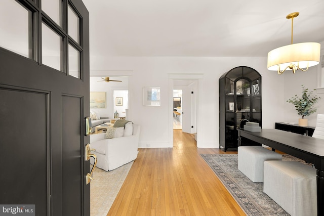 entryway with light wood-type flooring and baseboards