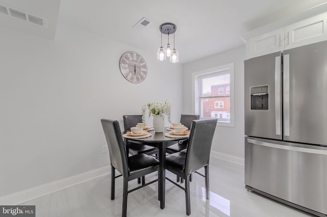 dining space featuring visible vents and baseboards