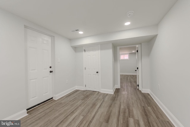 interior space featuring baseboards, wood finished floors, and recessed lighting