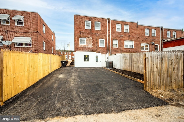 exterior space featuring central air condition unit and fence